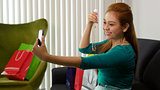 Latina Girl With Shopping Bags Taking Selfie With Phone