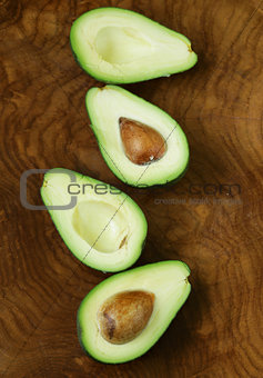 ripe organic avocado cut in half on a wooden background