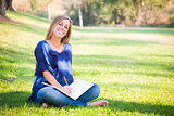Portrait of a Beautiful Young Woman With Book Outdoors