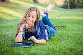 Smiling Young Woman Using Computer Tablet Outdoors