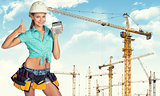 Young lady in hard hat holding calculator