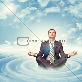 Businessman sitting in lotus position on circles