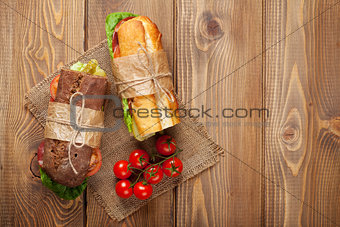 Two sandwiches with salad, ham, cheese