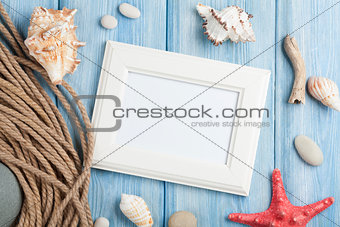 Sea vacation with blank photo frame, star fish and marine rope
