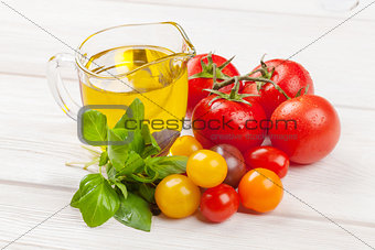 Fresh colorful tomatoes, basil and olive oil