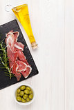 Prosciutto with rosemary, olives and olive oil