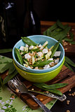 Fresh delicious cucumber, green peas, feta and pine nuts salad