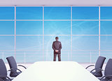 Businessman looking out office window