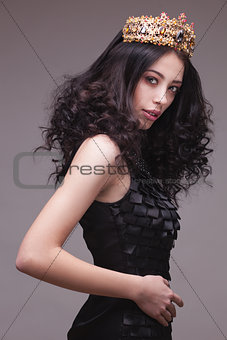 Fashion shot of a woman with diadem in black dress