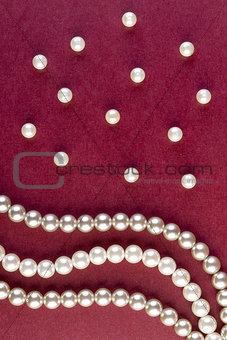Silver and White pearls necklace on dark red 