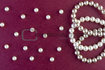 Silver and White pearls necklace on dark red  