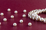 Silver and White pearls necklace on dark red 