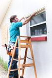 Contractor Measures Window