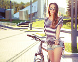 Fashion Hipster Woman with Bicycle in the City