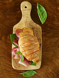 gourmet sandwich croissant with ham and basil