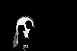 silhouettes of the bride and groom on the background of the arch