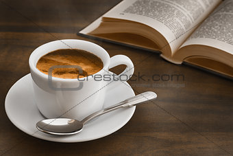 coffee on dark table with book