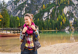 Portrait of smiling woman on Lake Bries readjusting scarf