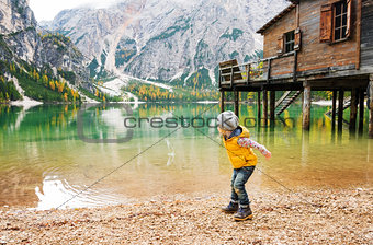 Young girl on Lake Bries in the autumn skipping stones