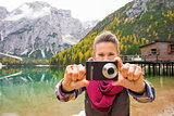 Woman on Lake Bries aiming digital camera at viewer