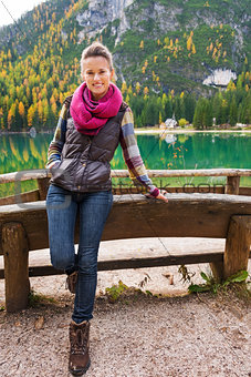 Woman hiker rests at edge of Lake Bries with pink scarf
