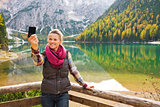 Woman hiker taking a selfie at Lake Bries with autumn colours
