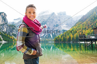 Smiling woman hiker at Lake Bries pointing at scenery