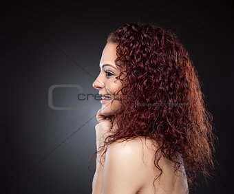 Profile view of a beauty with curly red hair