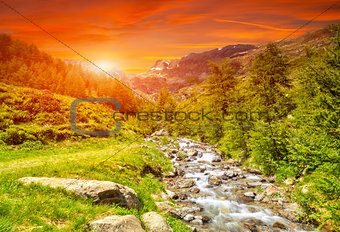 Colorful sunset and a river in the Alps