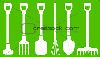 garden tools on green background