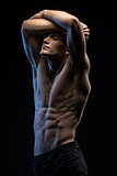 Portrait of handsome red-haired athlete topless at the studio