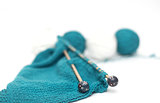 blue yarn knitted fabric, knitting spokes close-up