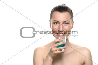 Smiling Young Woman holding Mouthwash in a glass