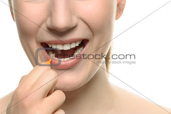 Woman cleaning between her teeth with an interdental brush