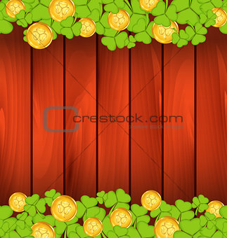 Clovers and golden coins on brown wooden background for St. Patr