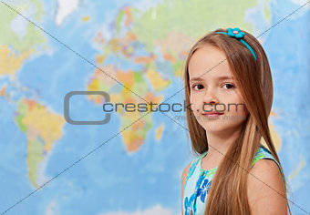 Young girl in front of world map