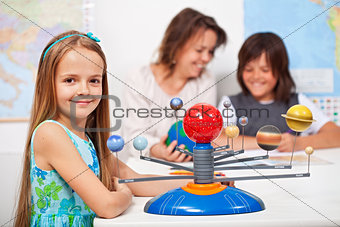 Geography class - little girl learning about the solar system