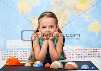 Little girl in elementary science class with her home project