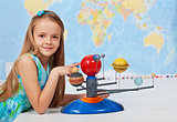 Young girl study solar system in science class