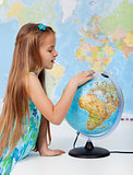 Young girl finding places on a globe