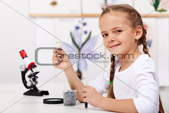 Young girl study plants in biology class