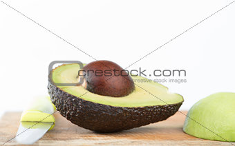Closed up half of Avocado fruit on white