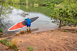 senior paddler launching  SUP paddleboard