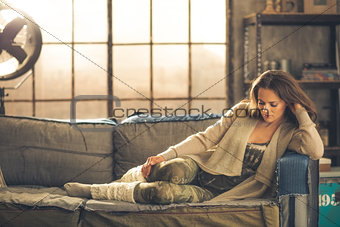 Woman sitting relaxing on a sofa dressed comfortably