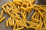 Yellow short macaroni pasta with empty space on hessian fabric cloth background