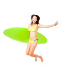 happy young Woman  holding surfboard and jumping