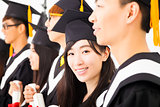 asian female college graduate at graduation with classmates