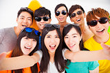 group of smiling friends with camera  taking self photo