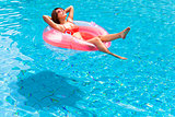 Young woman relaxing in swimming pool