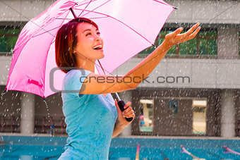 Beautiful young woman under pink umbrella